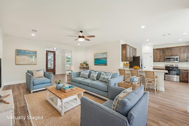 living area with ceiling fan, recessed lighting, visible vents, and light wood-type flooring