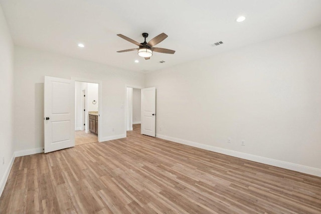 unfurnished bedroom featuring baseboards, light wood-style floors, and visible vents