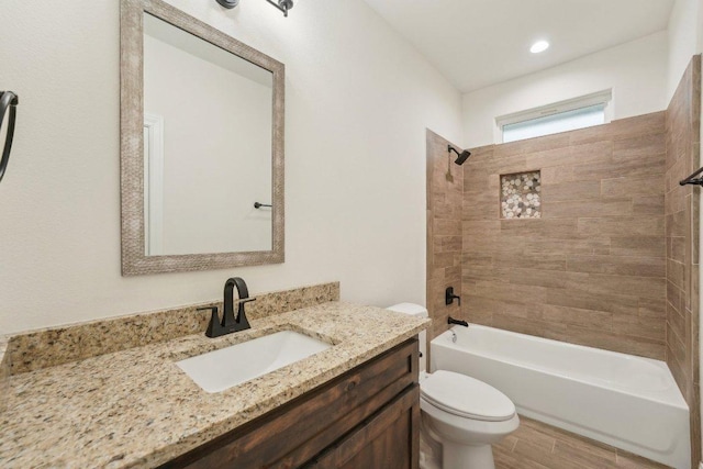 full bathroom with toilet, vanity, wood finished floors, and shower / tub combination