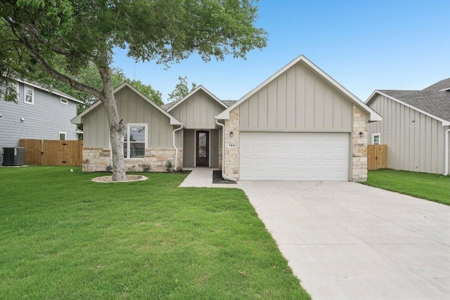 view of front of house with a front lawn, cooling unit, board and batten siding, an attached garage, and driveway