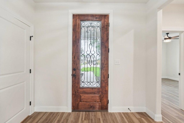 entrance foyer featuring baseboards and wood finished floors
