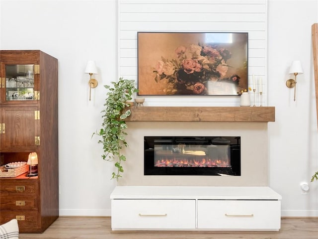 249 Earl Keen St, Leander, TX 78641 - detailed view of wood finished floors, baseboards, and a glass covered fireplace