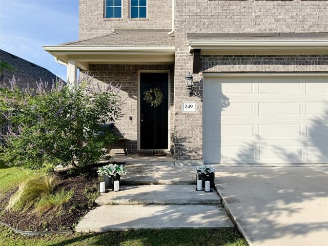 249 Earl Keen St, Leander, TX 78641 - entrance to property with a garage, brick siding, and concrete driveway