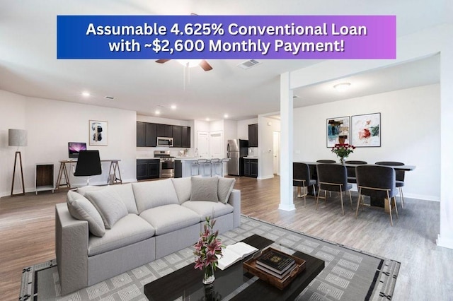 living room featuring ceiling fan, recessed lighting, visible vents, baseboards, and light wood-style floors