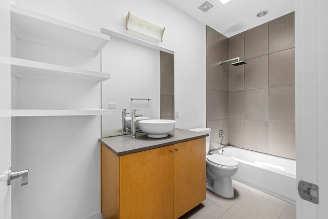 full bathroom with tile patterned flooring, toilet, vanity, and tiled shower / bath