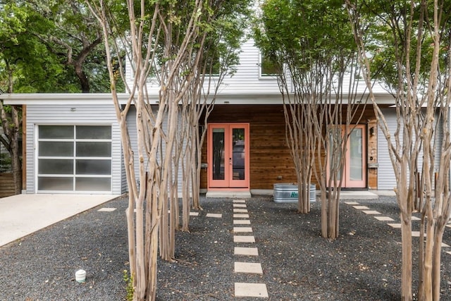 view of front of house with a garage and french doors