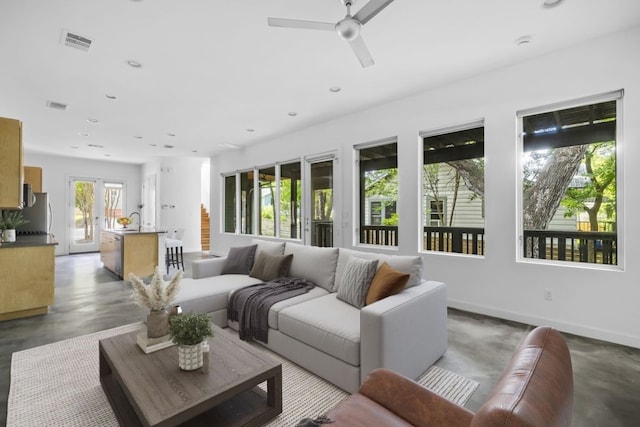 interior space featuring baseboards, visible vents, concrete flooring, and recessed lighting