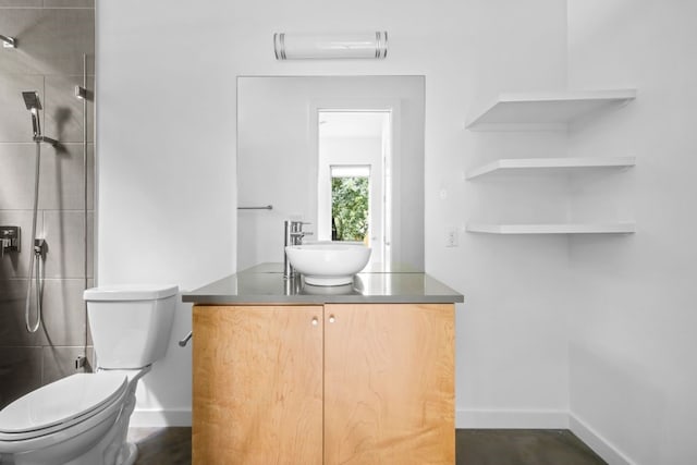 bathroom with a wall unit AC, toilet, vanity, and a tile shower