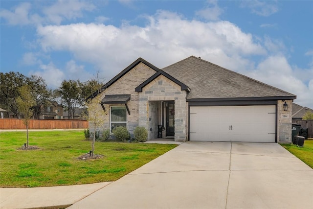 view of front of home featuring a front yard and a garage