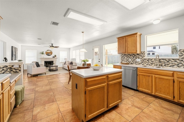 kitchen with hanging light fixtures, a kitchen island, sink, dishwasher, and decorative backsplash