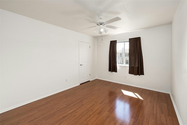 unfurnished room featuring dark wood-type flooring and ceiling fan