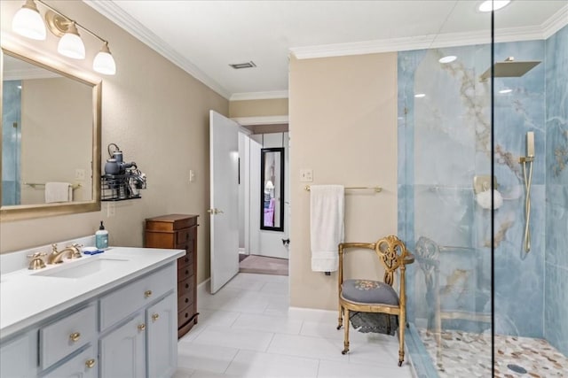 bathroom with a tile shower, vanity, and ornamental molding