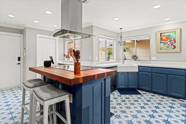 10920 Crown Colony Dr Unit C, Austin, TX 78747 - kitchen featuring wooden counters, light flooring, island exhaust hood, blue cabinetry, and black electric stovetop