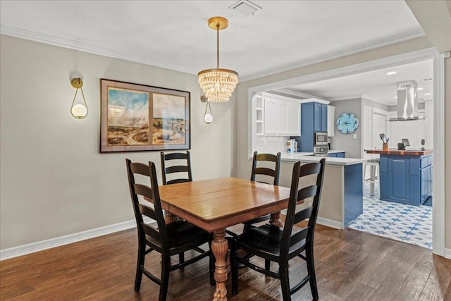 10920 Crown Colony Dr Unit C, Austin, TX 78747 - dining room featuring a chandelier, dark wood-type flooring, baseboards, and ornamental molding