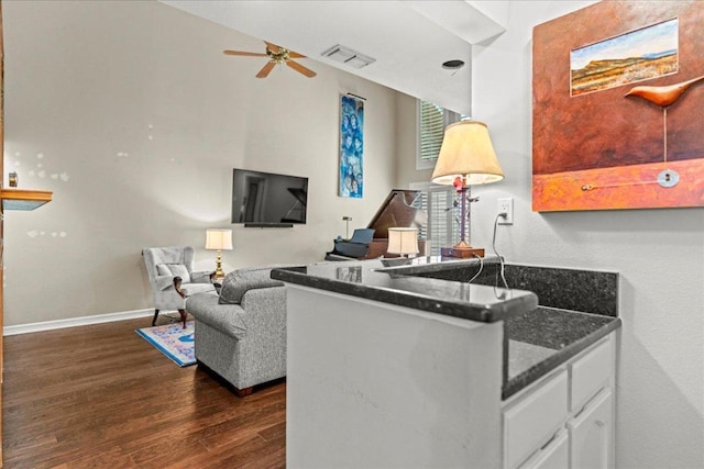 10920 Crown Colony Dr Unit C, Austin, TX 78747 - living room featuring dark wood finished floors, a ceiling fan, and baseboards