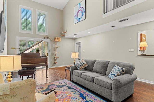 10920 Crown Colony Dr Unit C, Austin, TX 78747 - living area with baseboards, wood finished floors, and a towering ceiling