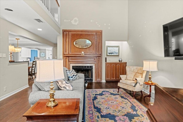 10920 Crown Colony Dr Unit C, Austin, TX 78747 - living room featuring a high ceiling, wood finished floors, baseboards, and a large fireplace