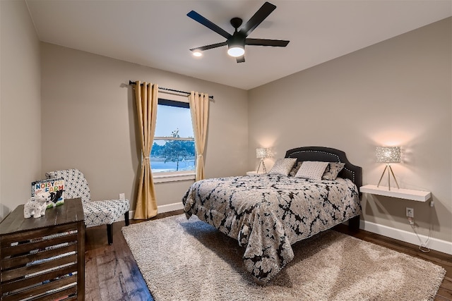 bedroom featuring ceiling fan and dark wood-type flooring