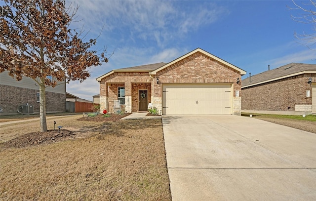 view of front of house with central AC, a front yard, and a garage