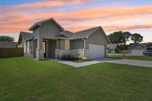 view of front of house featuring driveway, fence, a garage, board and batten siding, and a front yard