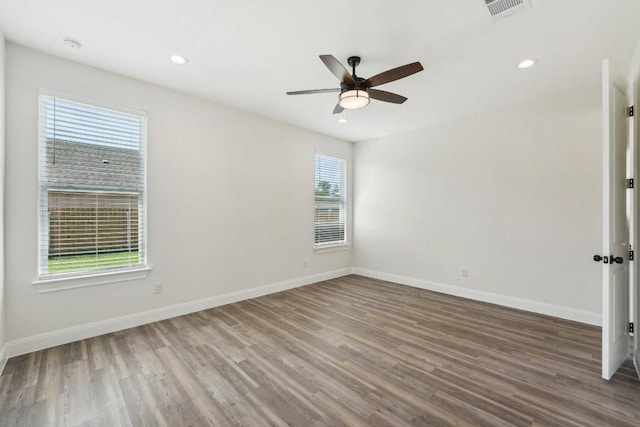 empty room featuring recessed lighting, wood finished floors, a ceiling fan, and baseboards