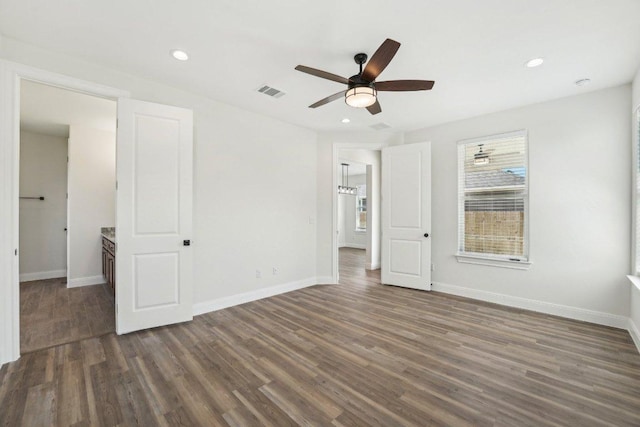 unfurnished bedroom featuring recessed lighting, baseboards, visible vents, and dark wood-style floors
