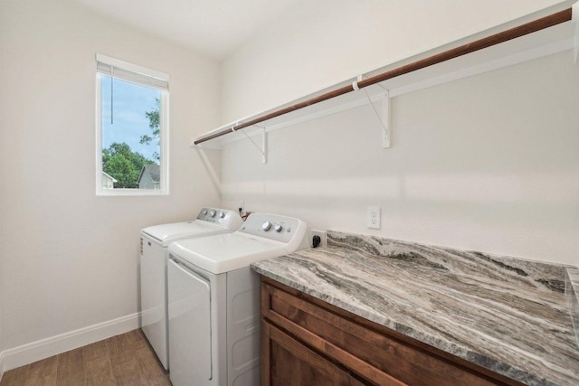 washroom with light wood-style floors, separate washer and dryer, baseboards, and laundry area