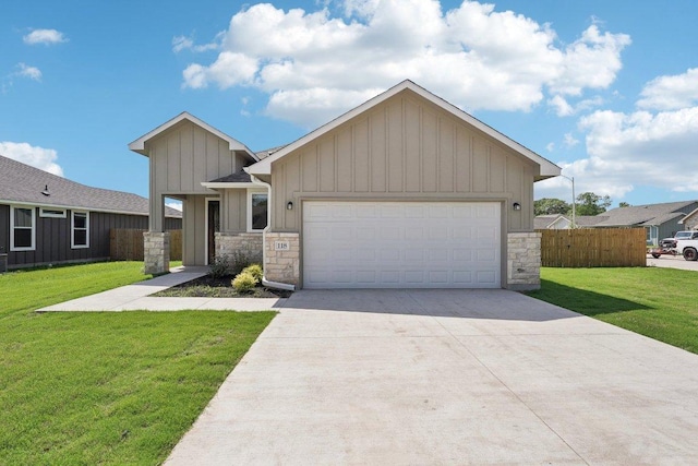 view of front facade with board and batten siding, stone siding, a front lawn, and concrete driveway