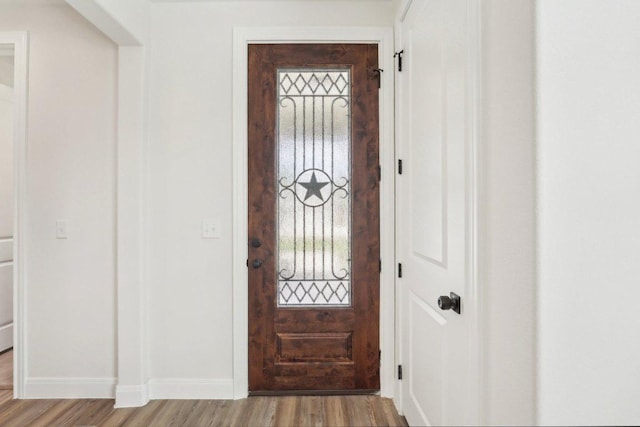 entryway featuring wood finished floors and baseboards