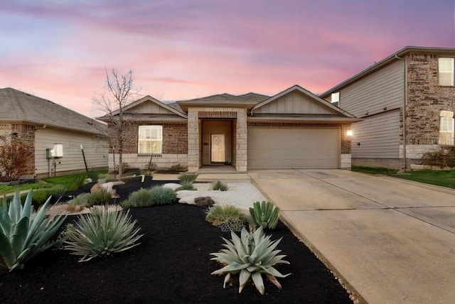 5812 Brampton Ln, Austin, TX 78724 - view of front of house with a garage, concrete driveway, board and batten siding, and brick siding