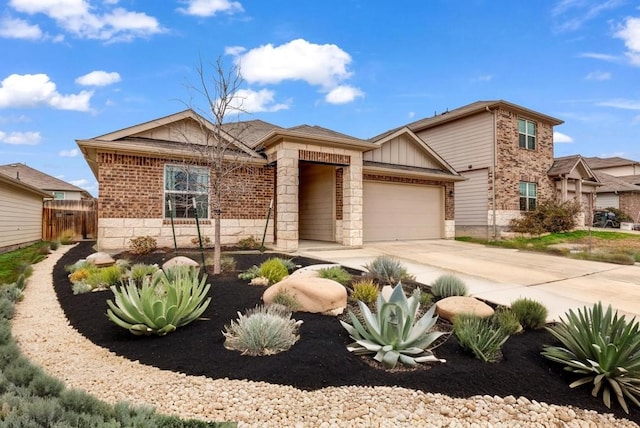 5812 Brampton Ln, Austin, TX 78724 - view of front facade with an attached garage, brick siding, driveway, and stone siding
