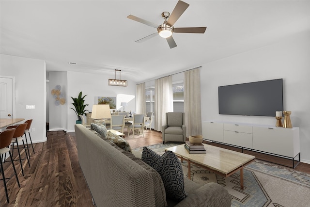 living room with ceiling fan with notable chandelier and wood-type flooring