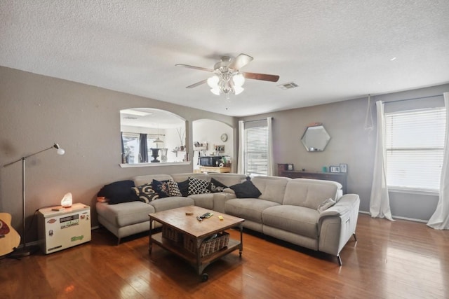 17405 Wiseman Dr, Pflugerville, TX 78660 - living room with a textured ceiling, a ceiling fan, wood finished floors, and plenty of natural light