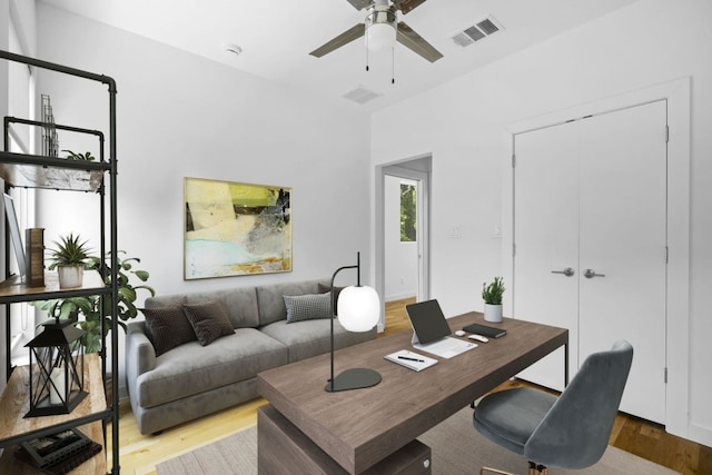 home office featuring wood finished floors, visible vents, and a ceiling fan