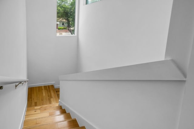 stairs featuring baseboards and wood finished floors