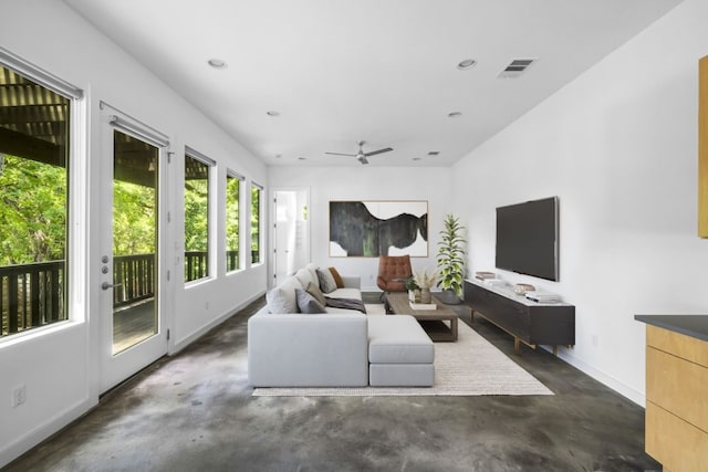 living room with baseboards, finished concrete floors, visible vents, and recessed lighting