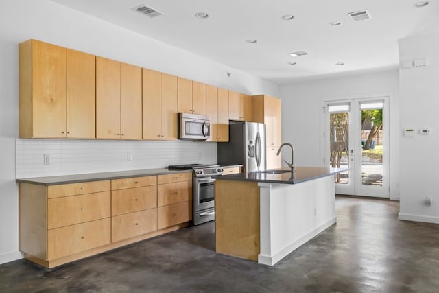 kitchen with appliances with stainless steel finishes, finished concrete floors, visible vents, and tasteful backsplash