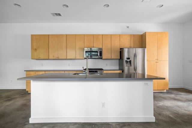 kitchen featuring finished concrete flooring, stainless steel appliances, visible vents, a sink, and an island with sink