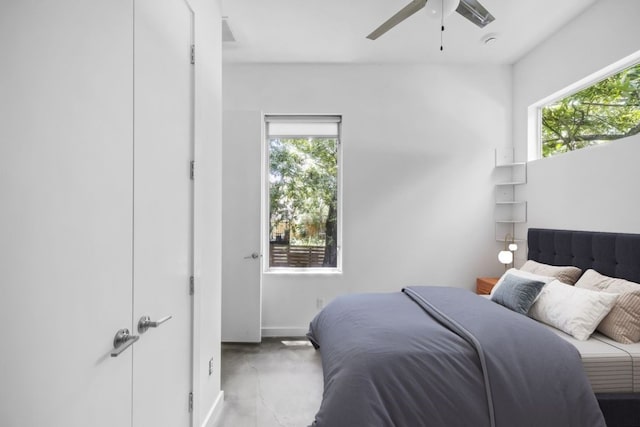 bedroom with concrete flooring and ceiling fan