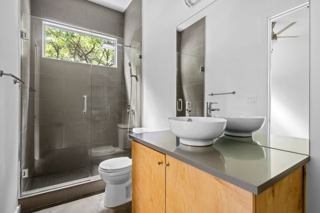 full bathroom with toilet, a shower stall, and vanity