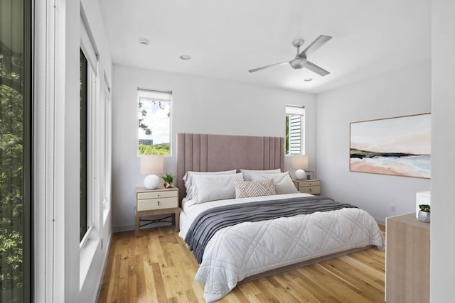 bedroom with light wood finished floors and a ceiling fan