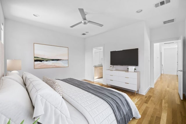 bedroom with visible vents, light wood-style flooring, and baseboards