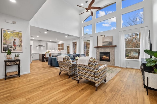 living room featuring ceiling fan and light hardwood / wood-style floors