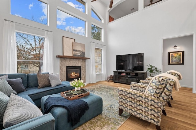 living room with a high ceiling and hardwood / wood-style floors