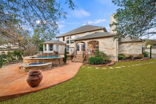 back of property featuring a patio, a lawn, and a fenced in pool