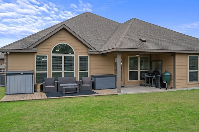 578 Ledge Stone Dr, Austin, TX 78737 - back of house featuring a jacuzzi, a wooden deck, ceiling fan, a shingled roof, and a lawn