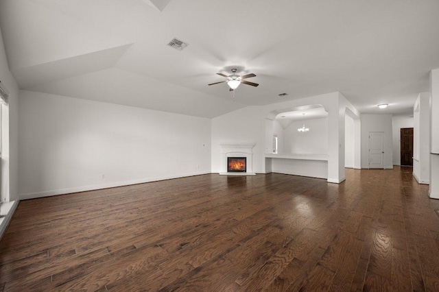 578 Ledge Stone Dr, Austin, TX 78737 - unfurnished living room featuring a ceiling fan, dark wood finished floors, a chandelier, a lit fireplace, and baseboards