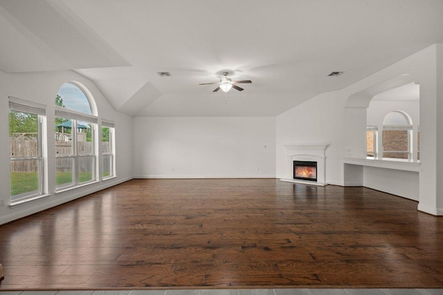 578 Ledge Stone Dr, Austin, TX 78737 - unfurnished living room with wood finished floors, vaulted ceiling, a ceiling fan, a glass covered fireplace, and baseboards