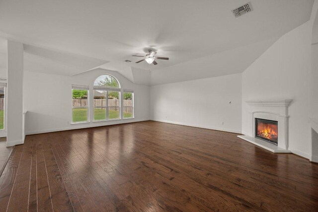 578 Ledge Stone Dr, Austin, TX 78737 - unfurnished living room featuring vaulted ceiling, ceiling fan, hardwood / wood-style flooring, a glass covered fireplace, and baseboards
