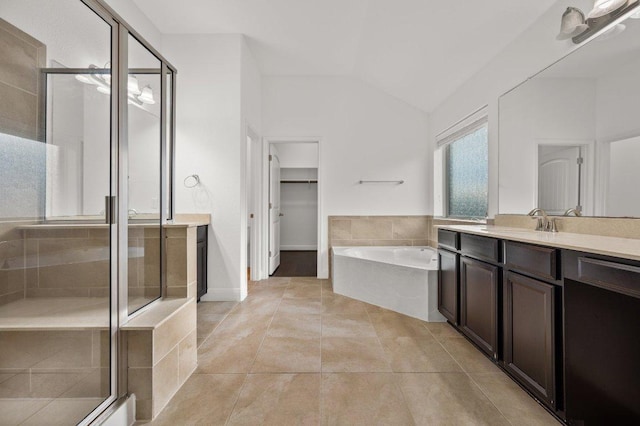 578 Ledge Stone Dr, Austin, TX 78737 - bathroom featuring lofted ceiling, a stall shower, vanity, a bath, and tile patterned flooring